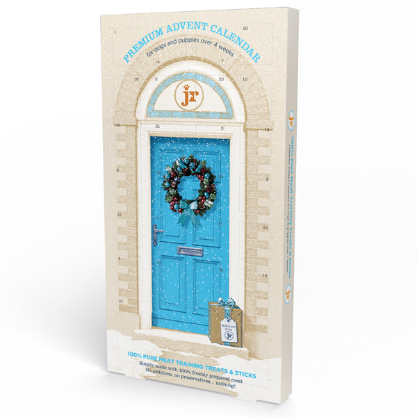 JR Pure Dog Advent Calendar | Christmas Dog Treats Ostrich. Premium Advent Calendar for dogs and puppies, featuring a front cover illustration of a bright blue door with a festive wreath, set against a clean white background.