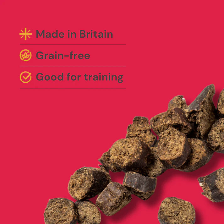 Dog treats on a red background with text indicating 'Made in Britain', 'Grain-free', and 'Good for training'.