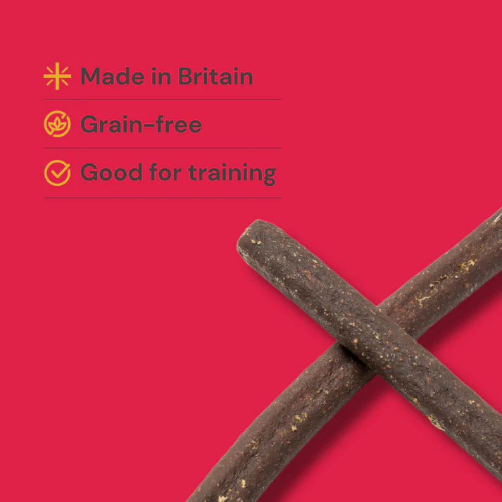 Dog treats on a red background with text indicating 'Made in Britain', 'Grain-free', and 'Good for training'.