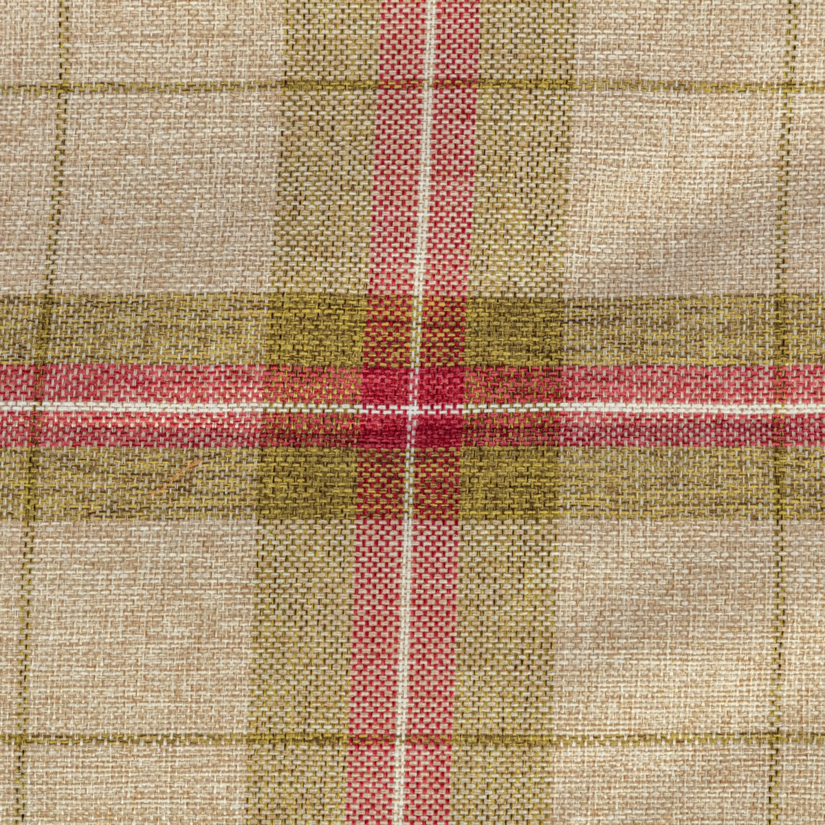 A close-up of a woven fabric with a plaid pattern in beige, olive green, and pink, showing the detailed textile texture.