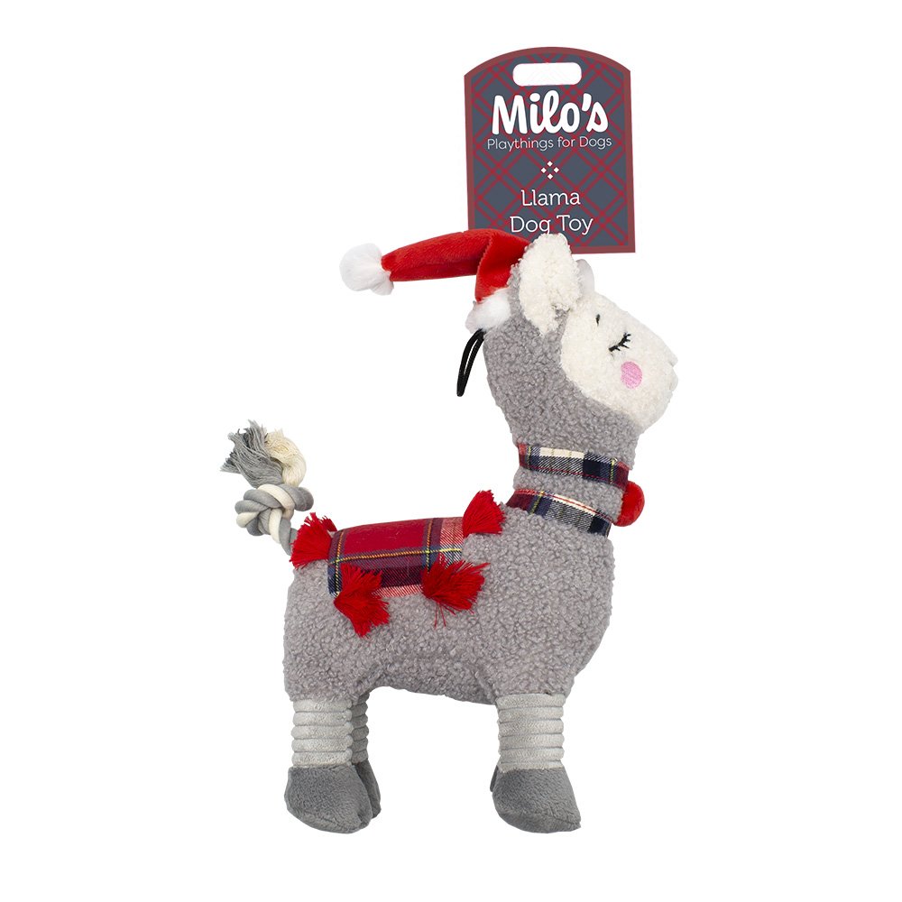 A plush llama dog toy in gray with red holiday accessories, including a Santa hat, plaid scarf, and tail, shown with its retail hang tag on a white background.
