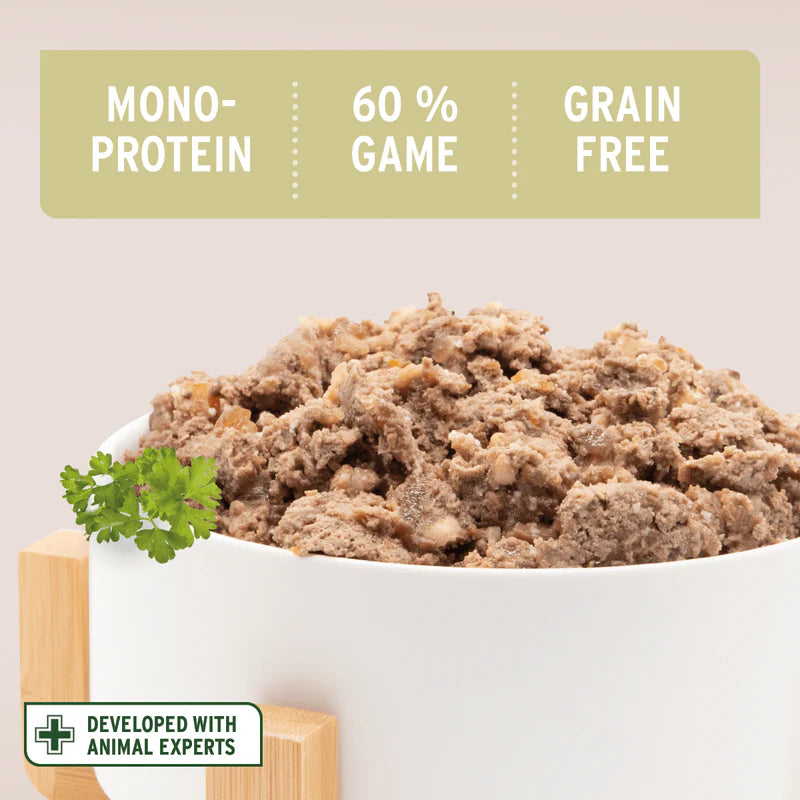 Text on a green label above a bowl of pet food with 'Mono-Protein', '60% Game', 'Grain Free' text, and a green leaf garnish.