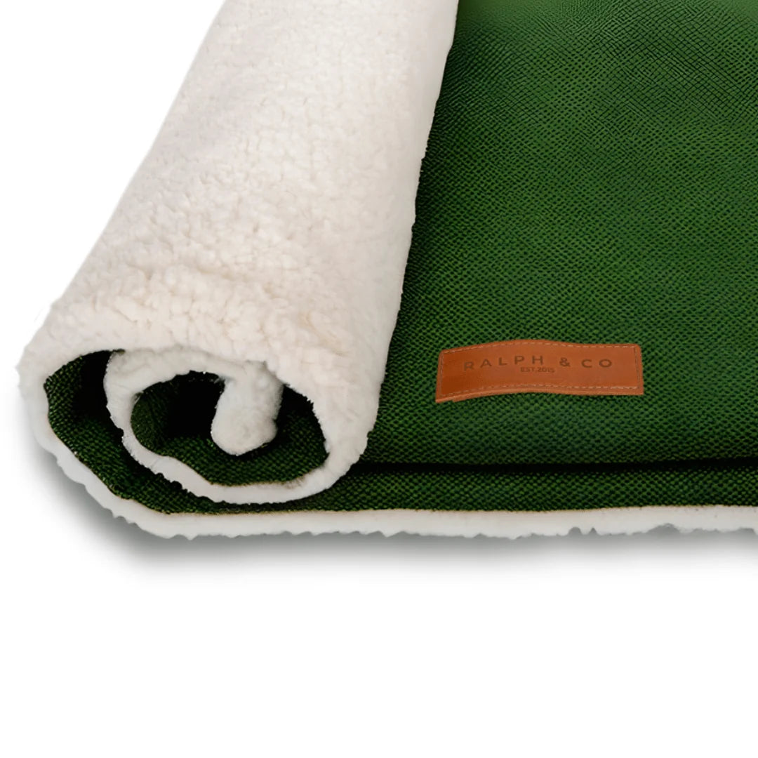 Green and white textured blanket from Ralph & Co on a white background 