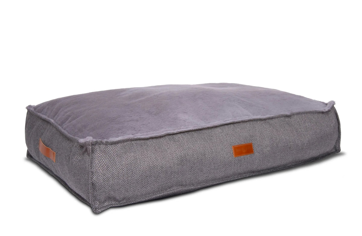 Gray pet bed with orange accents on a white background