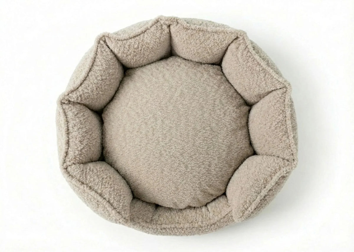 A round, plush pet bed with a raised octagonal border, shown from a top-down view on a clean white background.