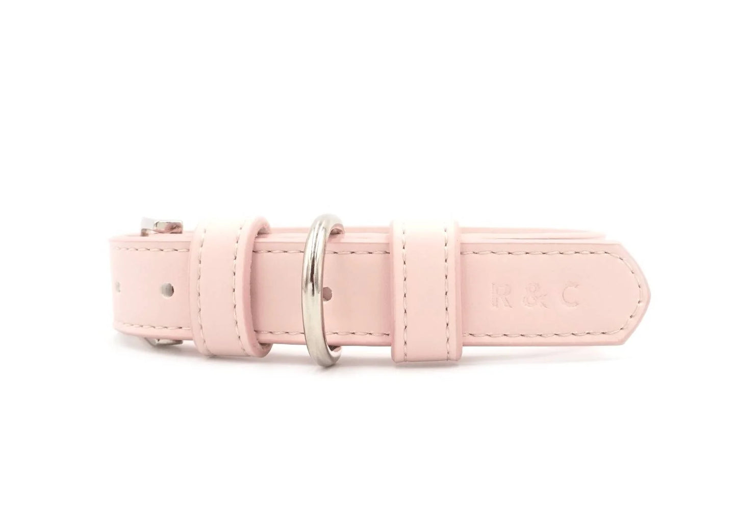 A light pink leather belt with silver-tone metal hardware, featuring an embossed 'R&C' logo on the tip, shown against a plain white background.
