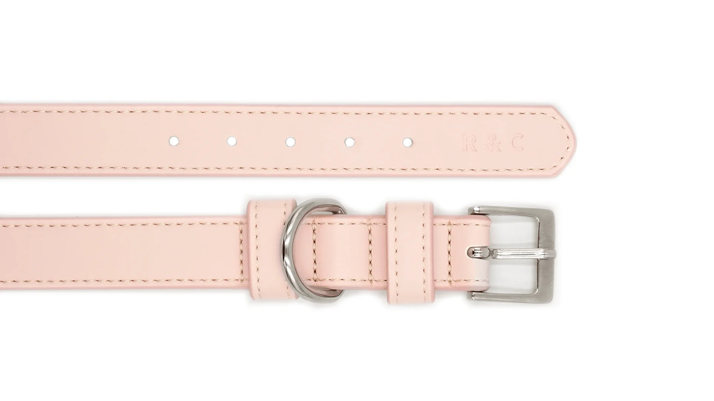 A light pink faux leather collar strap shown from two angles on a white background, featuring a silver-tone buckle and a silver-tone loop.