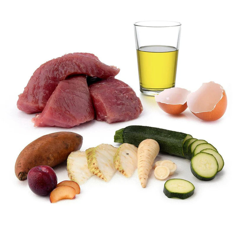 Assorted food items including meat, vegetables, and a glass of liquid on a white background